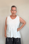 Corded sleeveless tank shown in black and white, with a scoop neckline, relaxed A-line silhouette, abstract raised crisscross cord detailing on the front, softly uneven raw-edge hem, and a clean unembellished back.