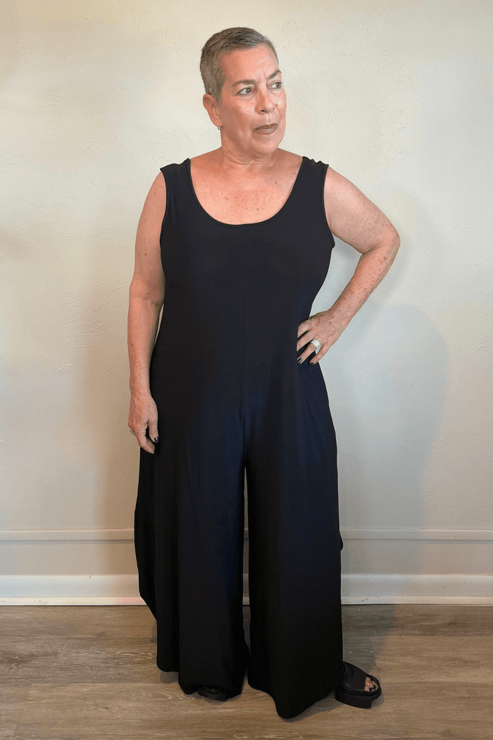 Model wearing the black Kozan Dawn sleeveless wide-leg jumpsuit, shown from front and back.