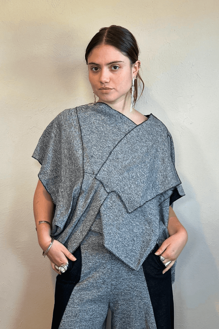 Model wearing the Kozan Fari draped top in heathered gray with black contrast edging, shown from front and back, including a full outfit view with coordinating pants.