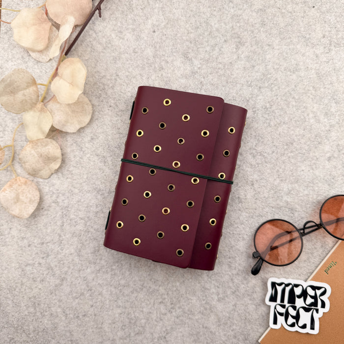 Imperfect Concepts Juniper Leather Notebook - A6 Trifold - Maroon w/ Gold & Brass Grommets