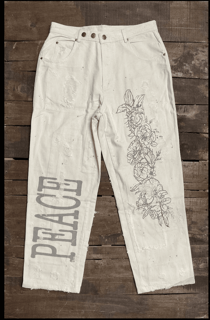 Jaded Gypsy Parchment Peace And Love Jeans with distressed details, PEACE leg graphic, floral artwork, and embroidered back design
