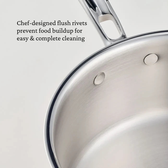 Close-up of the CopperBond Aura™ Polished Copper 0.75-Quart Butter Warmer highlights the flush stainless steel rivets on the interior. The image text notes that these chef-designed flush rivets prevent food buildup for easy, thorough cleaning—just as you’d expect from professional-grade copper cookware.